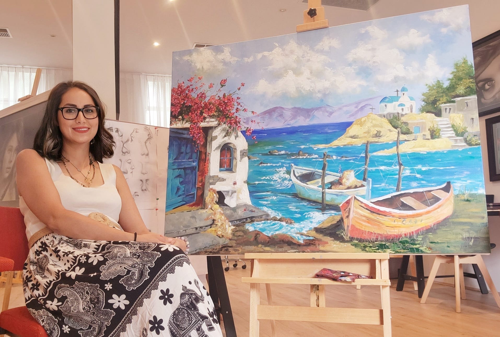Elnaz with a Mediterranean seascape oil painting