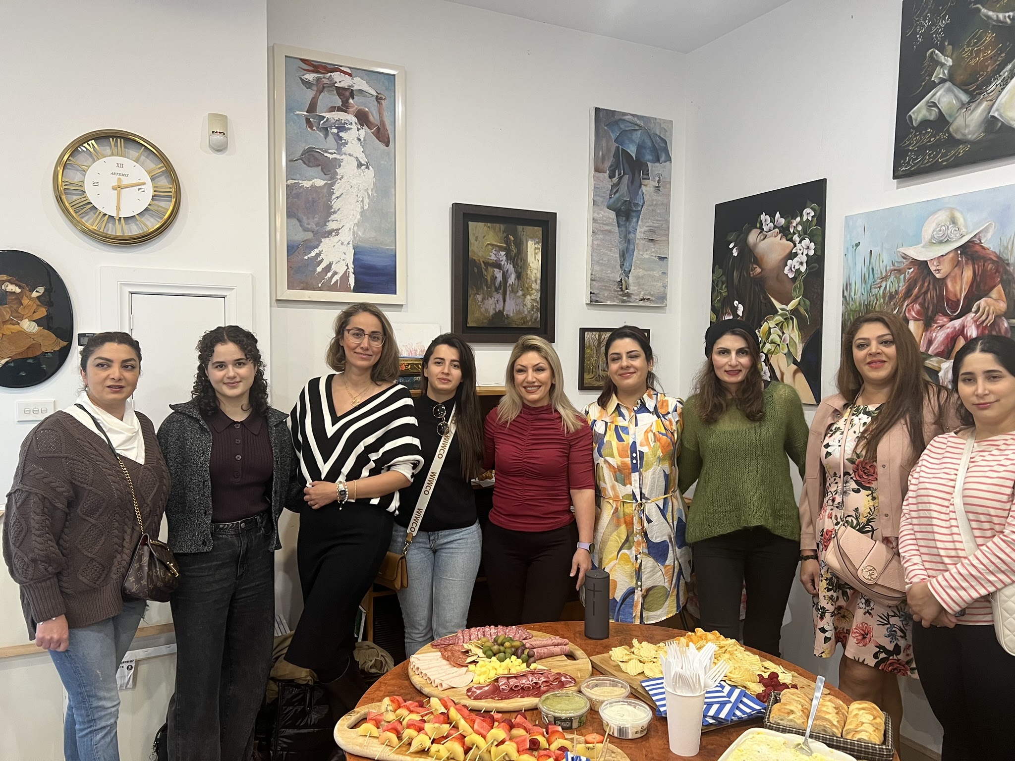 Students gathered in the studio among their finished paintings