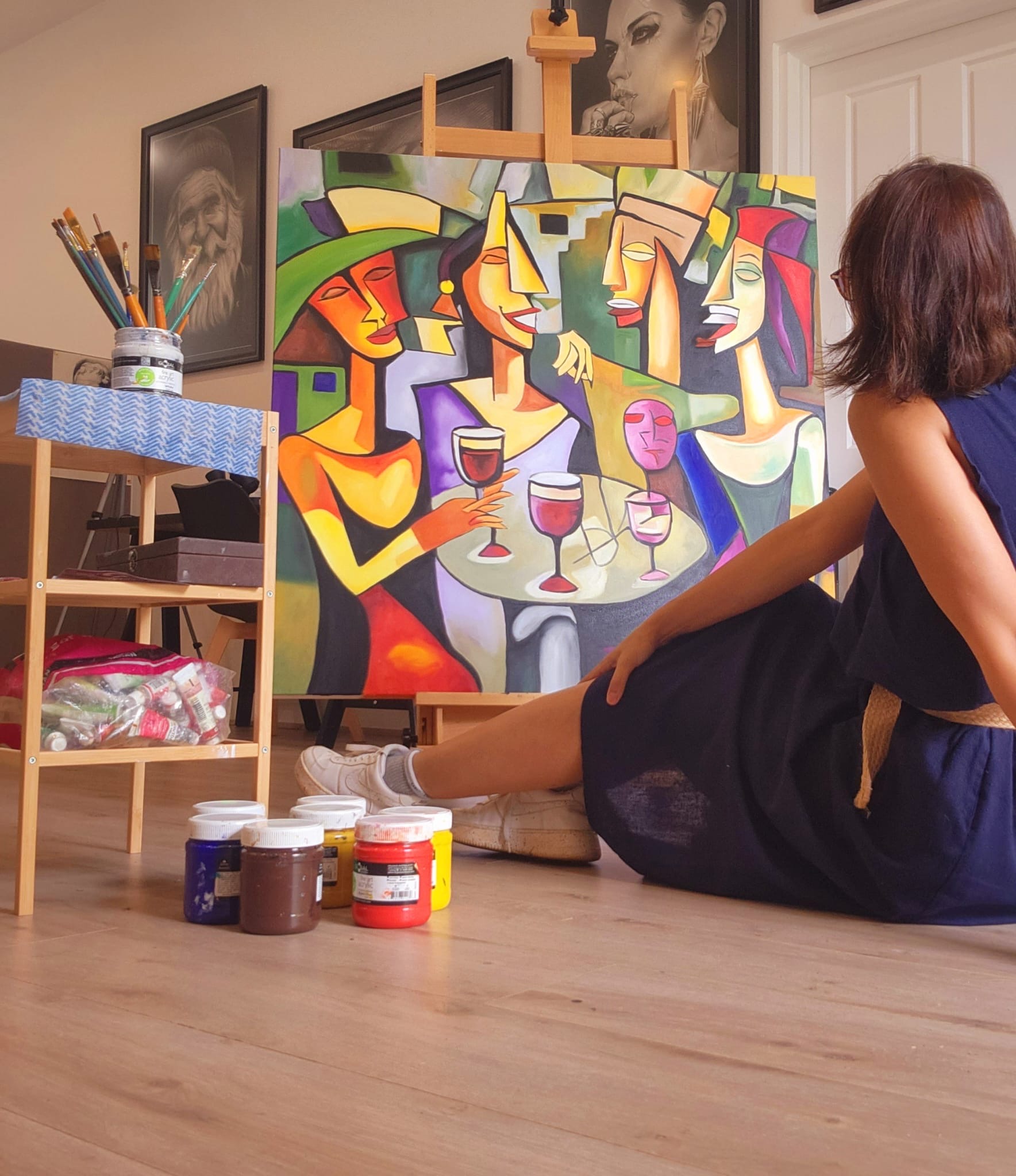 A painter at work on a colourful canvas in the studio